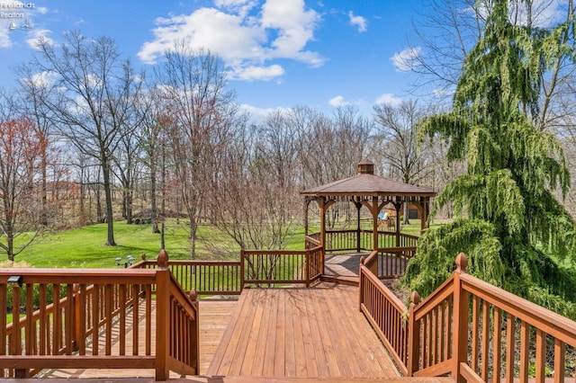wooden terrace with a gazebo and a yard