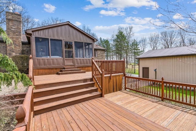 deck featuring a sunroom and stairway
