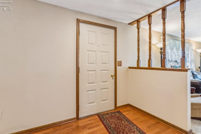 entryway with baseboards and light wood-style flooring