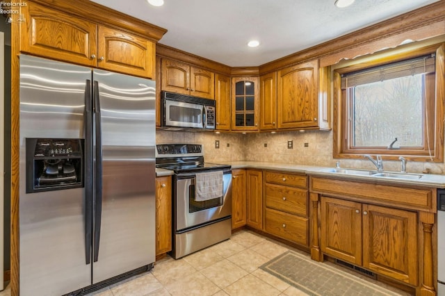 kitchen featuring visible vents, a sink, brown cabinets, and appliances with stainless steel finishes