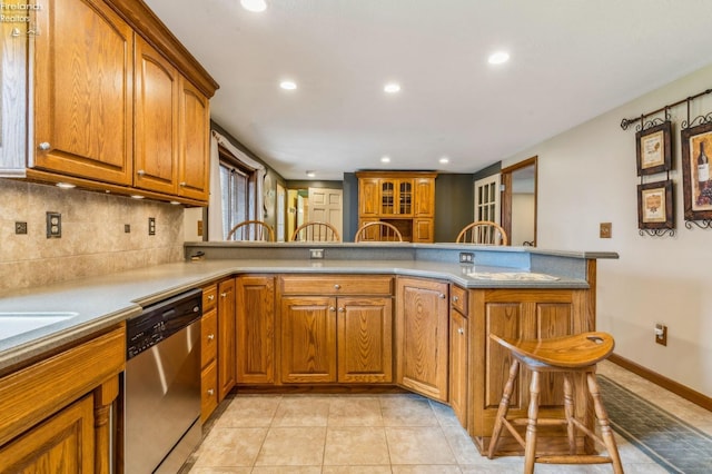 kitchen with recessed lighting, brown cabinetry, stainless steel dishwasher, and decorative backsplash