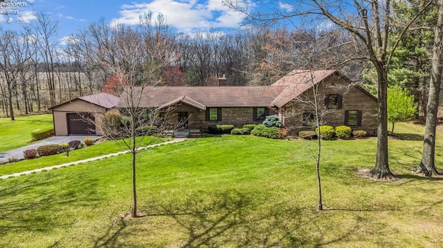 ranch-style home with a garage, driveway, a front lawn, and brick siding