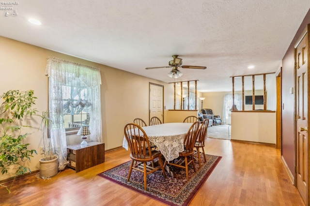 dining space with recessed lighting, wood finished floors, a ceiling fan, and baseboards