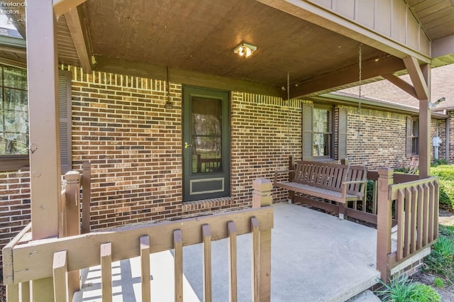 doorway to property with brick siding and board and batten siding