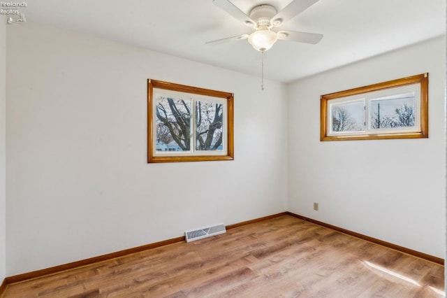 unfurnished room with plenty of natural light, visible vents, baseboards, and light wood-style flooring