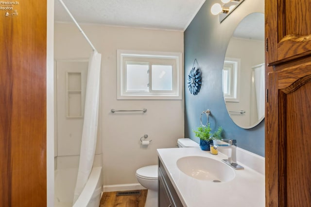 bathroom featuring visible vents, a wealth of natural light, vanity, and toilet