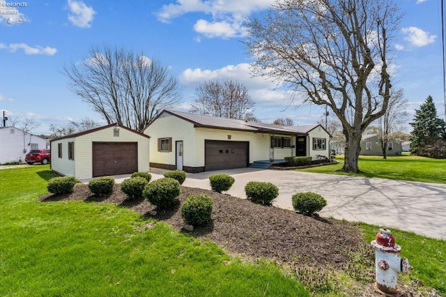 ranch-style house featuring concrete driveway, a front lawn, and a garage