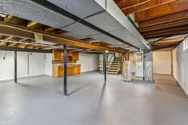 unfinished below grade area featuring stairs, concrete block wall, heating unit, and gas water heater