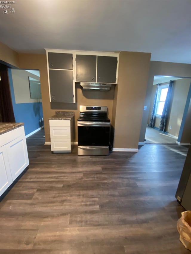 457 Morrison St, Fremont, OH 43420 - kitchen featuring white cabinets, under cabinet range hood, baseboards, stainless steel electric range, and dark wood-style flooring