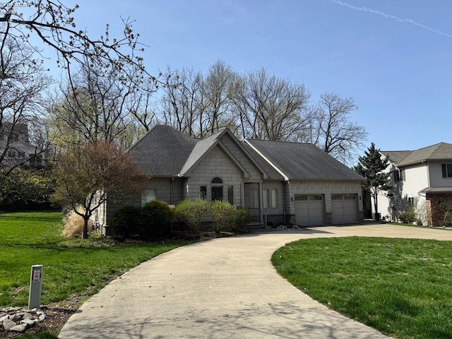 ranch-style house with roof with shingles, an attached garage, concrete driveway, and a front lawn