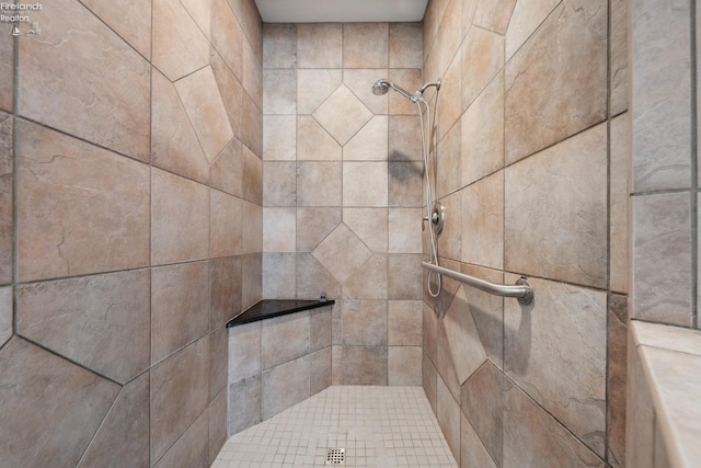 full bath with a tile shower