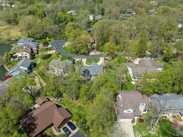 birds eye view of property with a forest view and a residential view