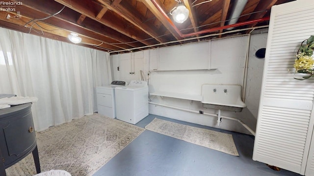 unfinished basement featuring separate washer and dryer and a sink