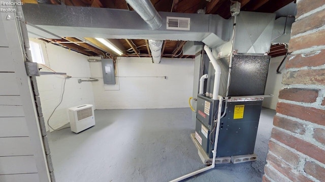 unfinished basement with electric panel and visible vents