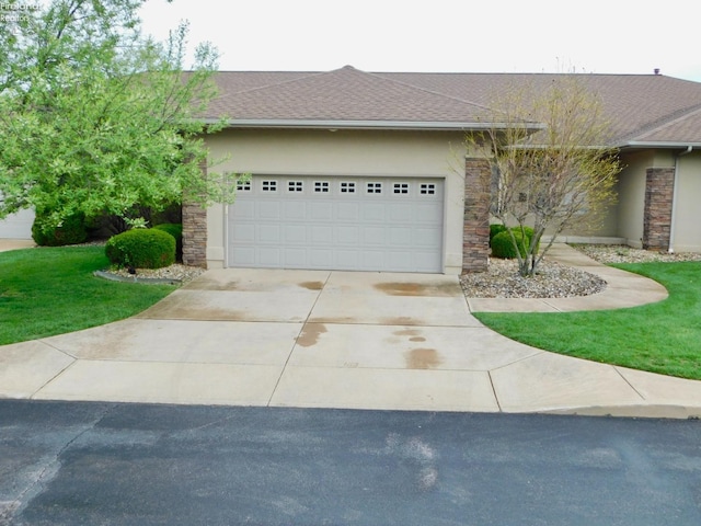 view of front facade featuring a shingled roof, stucco siding, an attached garage, driveway, and stone siding