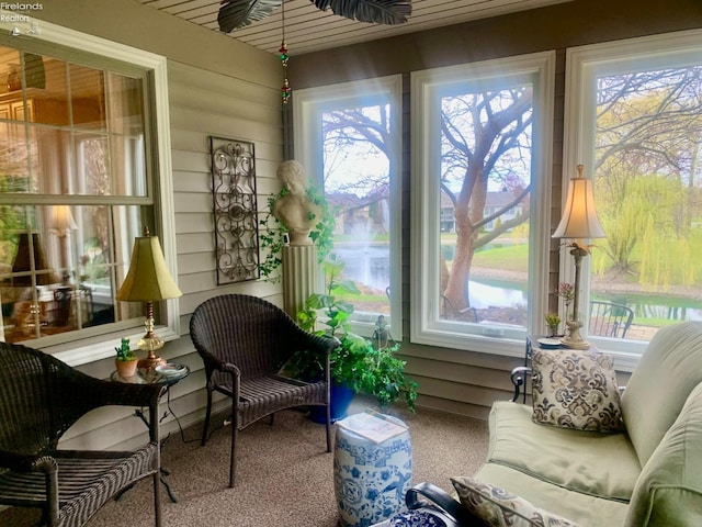 sunroom / solarium with carpet floors and plenty of natural light