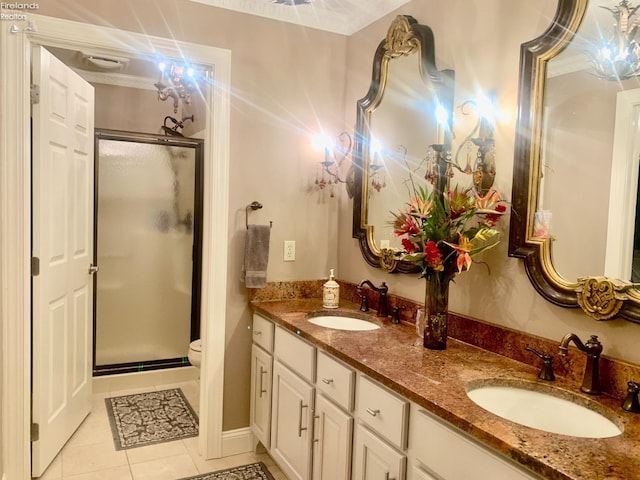 bathroom featuring tile patterned floors, a sink, and a stall shower