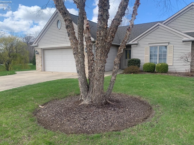 ranch-style home with an attached garage, driveway, a shingled roof, and a front lawn