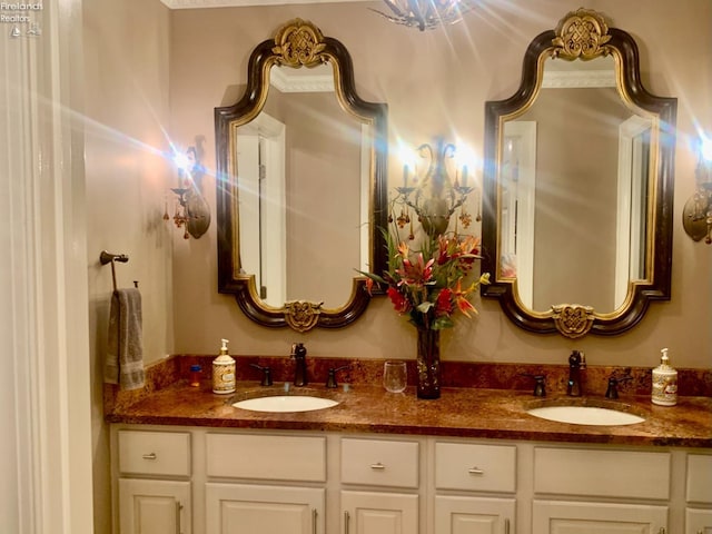 bathroom featuring a sink and double vanity