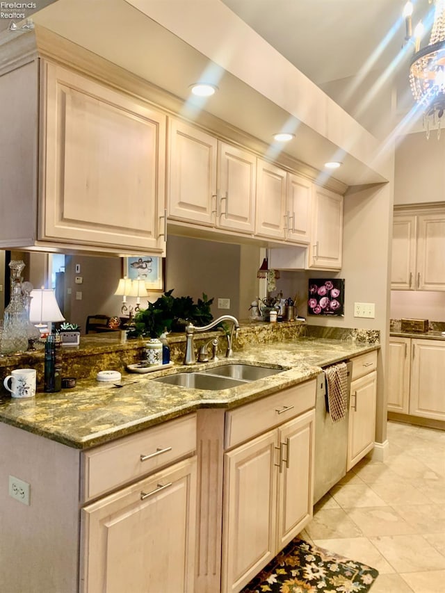 kitchen featuring dishwasher, light stone countertops, a sink, and light tile patterned floors