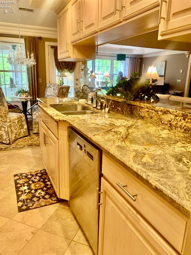 kitchen featuring stainless steel dishwasher, light stone counters, a sink, a notable chandelier, and visible vents