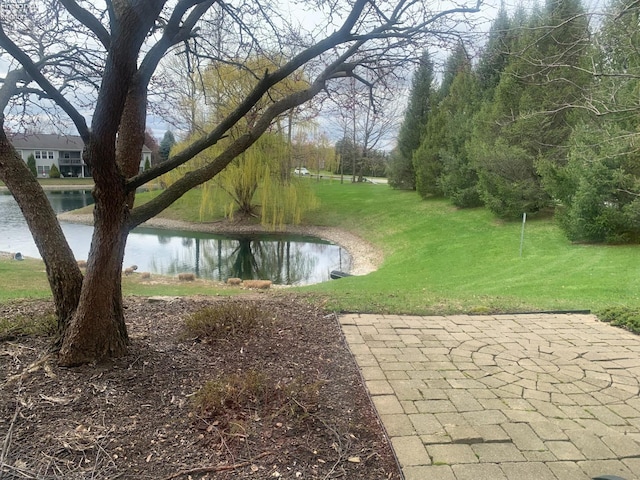 view of community with a yard and a water view