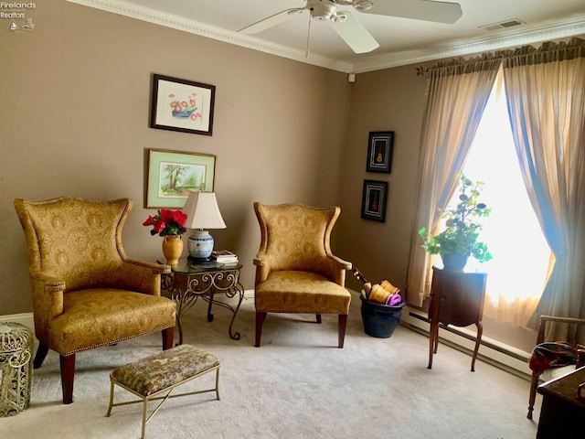 living area with a baseboard heating unit, crown molding, visible vents, and plenty of natural light