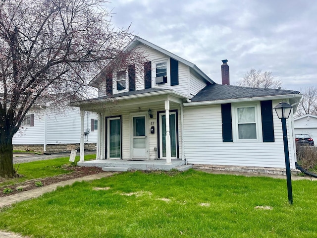 view of front of property featuring a shingled roof, a chimney, a porch, and a front lawn