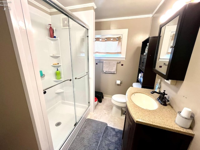 bathroom with vanity, toilet, baseboards, a shower stall, and ornamental molding
