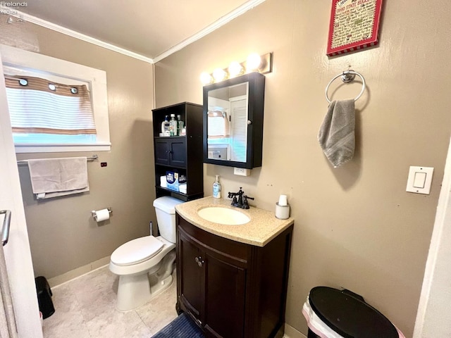 bathroom featuring crown molding, tile patterned flooring, vanity, toilet, and baseboards