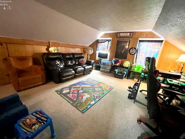 playroom featuring a textured ceiling, wood walls, carpet, and vaulted ceiling