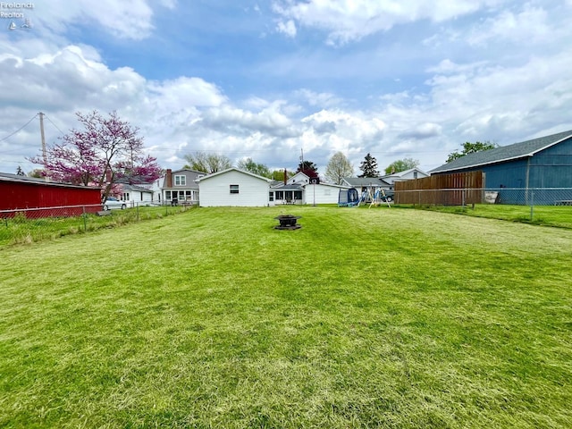 view of yard featuring fence and an outdoor fire pit