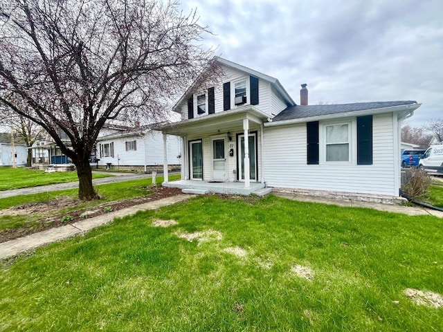view of front of property featuring covered porch, a chimney, and a front lawn