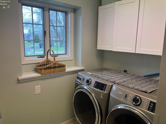 clothes washing area with cabinet space and separate washer and dryer