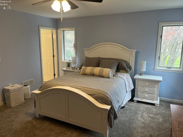 bedroom featuring ceiling fan, baseboards, multiple windows, and carpet