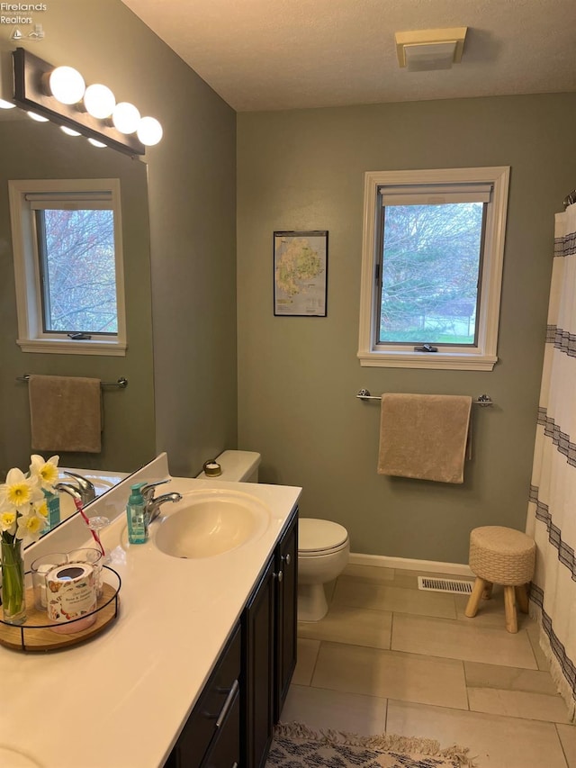 full bathroom featuring baseboards, visible vents, tile patterned floors, and vanity