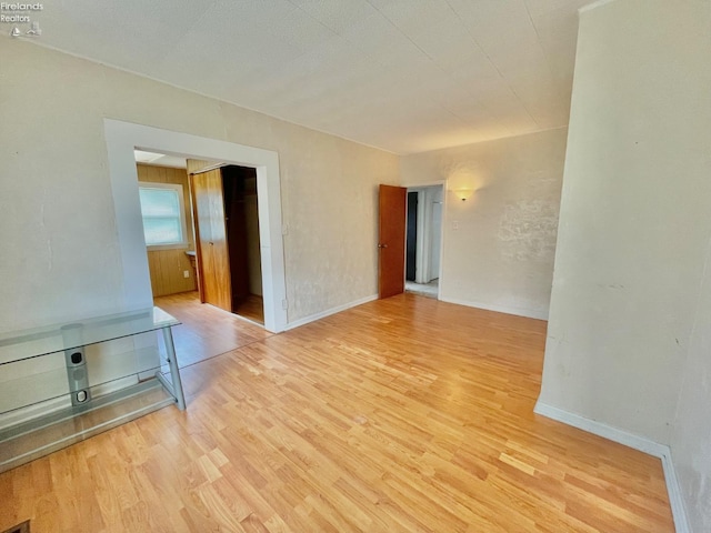 spare room with wood finished floors and baseboards