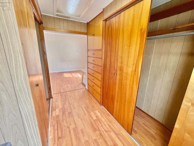 hall with wooden walls and wood finished floors
