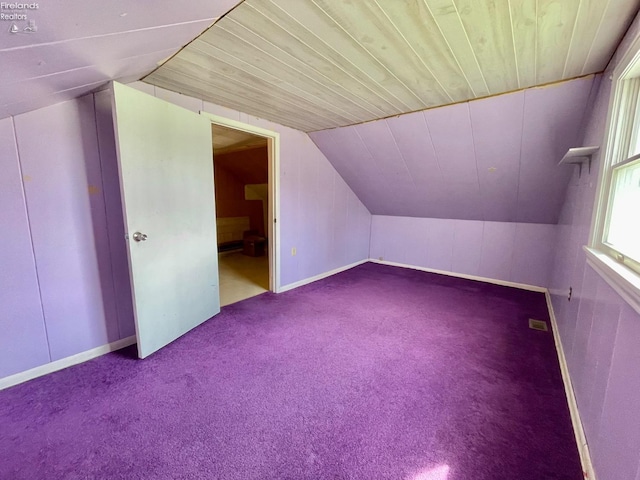 additional living space featuring wood ceiling, lofted ceiling, visible vents, and carpet floors