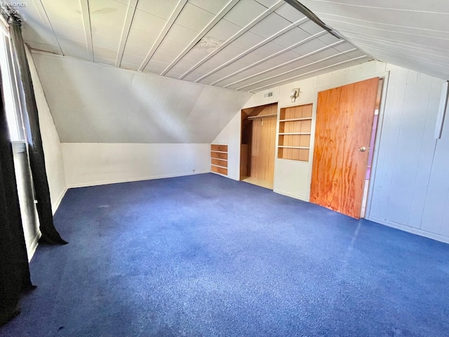bonus room featuring vaulted ceiling and carpet floors