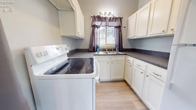 laundry area featuring a sink and light wood-type flooring