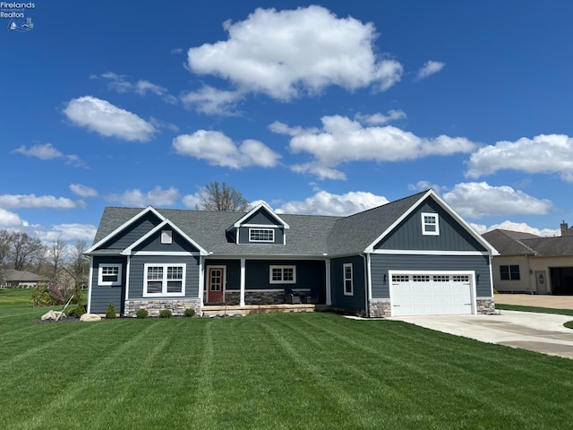 craftsman-style home featuring concrete driveway, a front lawn, stone siding, board and batten siding, and a porch