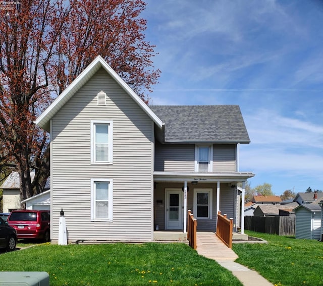 113 W Grant St, Clyde, OH 43410 - traditional home featuring a porch, a shingled roof, and a front lawn