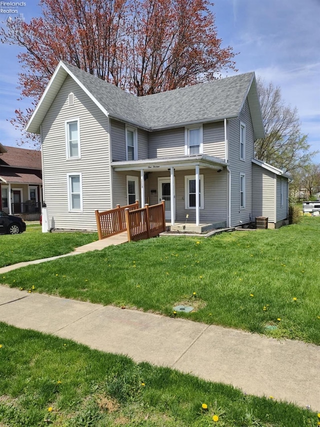 113 W Grant St, Clyde, OH 43410 - traditional home with a shingled roof, covered porch, and a front lawn
