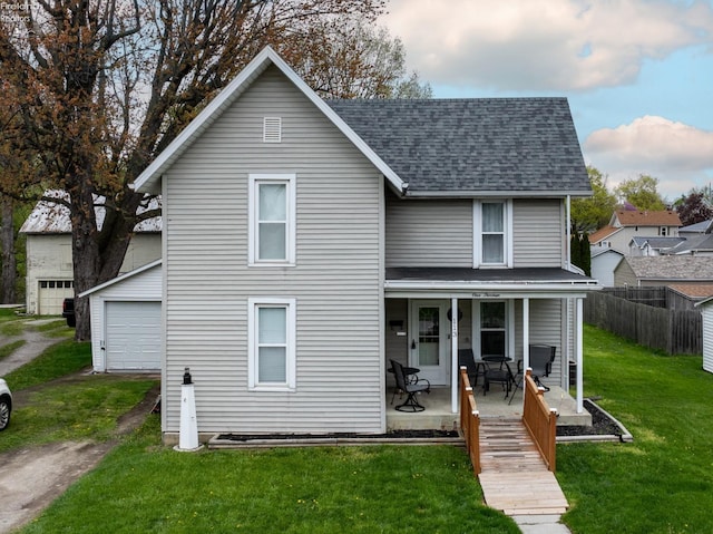 113 W Grant St, Clyde, OH 43410 - back of house featuring fence, a porch, a yard, and roof with shingles