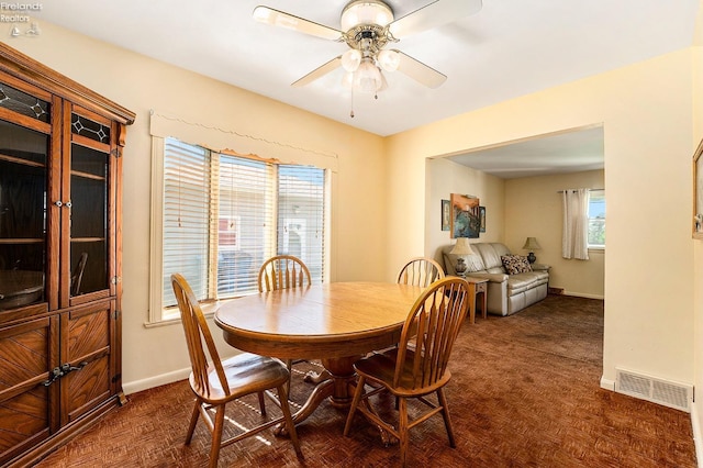 dining space featuring visible vents, ceiling fan, and baseboards
