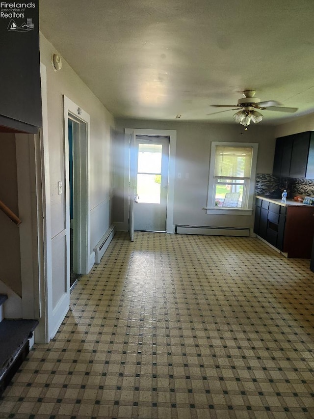 1501 E State St, Port Clinton, OH 43452 - unfurnished living room featuring baseboard heating, carpet, stairs, and baseboards