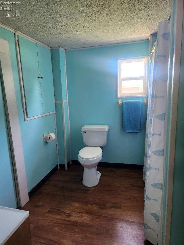 1501 E State St, Port Clinton, OH 43452 - bathroom featuring wood finished floors, toilet, and a textured ceiling