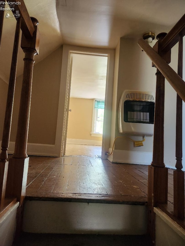 1501 E State St, Port Clinton, OH 43452 - staircase with heating unit, vaulted ceiling, baseboards, and wood-type flooring