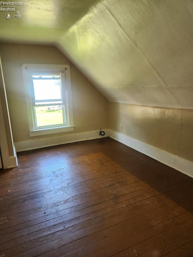 1501 E State St, Port Clinton, OH 43452 - bonus room featuring dark wood-style flooring, vaulted ceiling, and baseboards